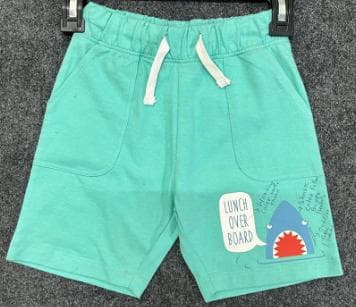 Teal kids knit shorts with a shark print and patch pockets